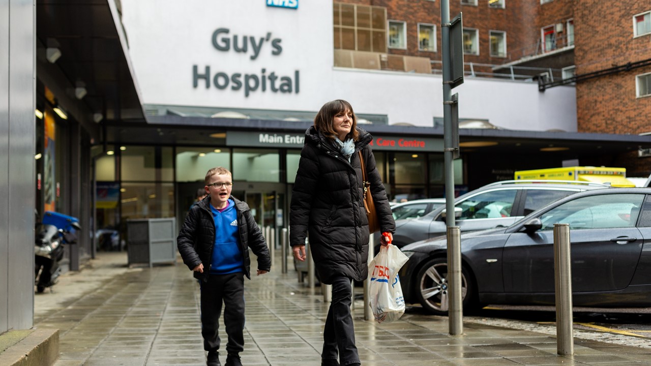 Mother and son walking outside Guy's Hospital