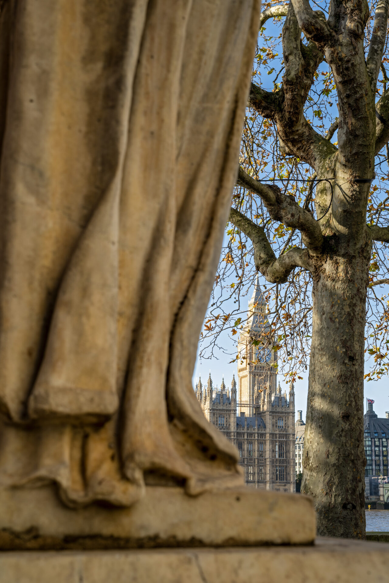 Base of Sir Robert Clayton statue, with Houses of Parliament in the background