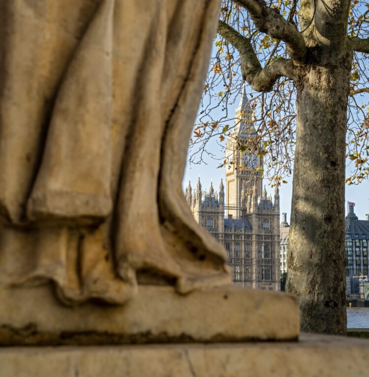 The base of Sir Robert Clayton statue sits in the photograph's foreground, with Big Ben in the background