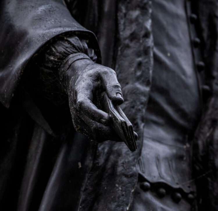 A close-up photograph of the hand of the statue of Thomas Guy