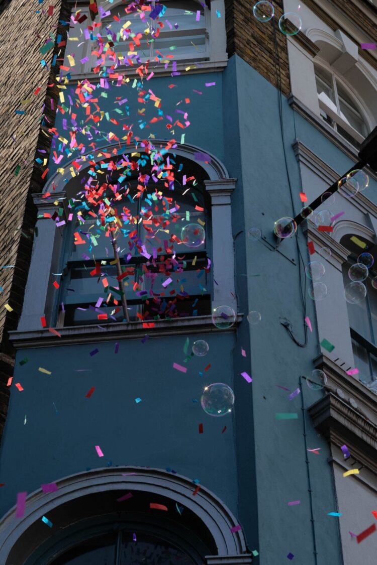 Confetti falls in front of a London window. Photograph by Clem Onojeghuo