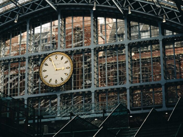 Ornate clock on industrial metal structure