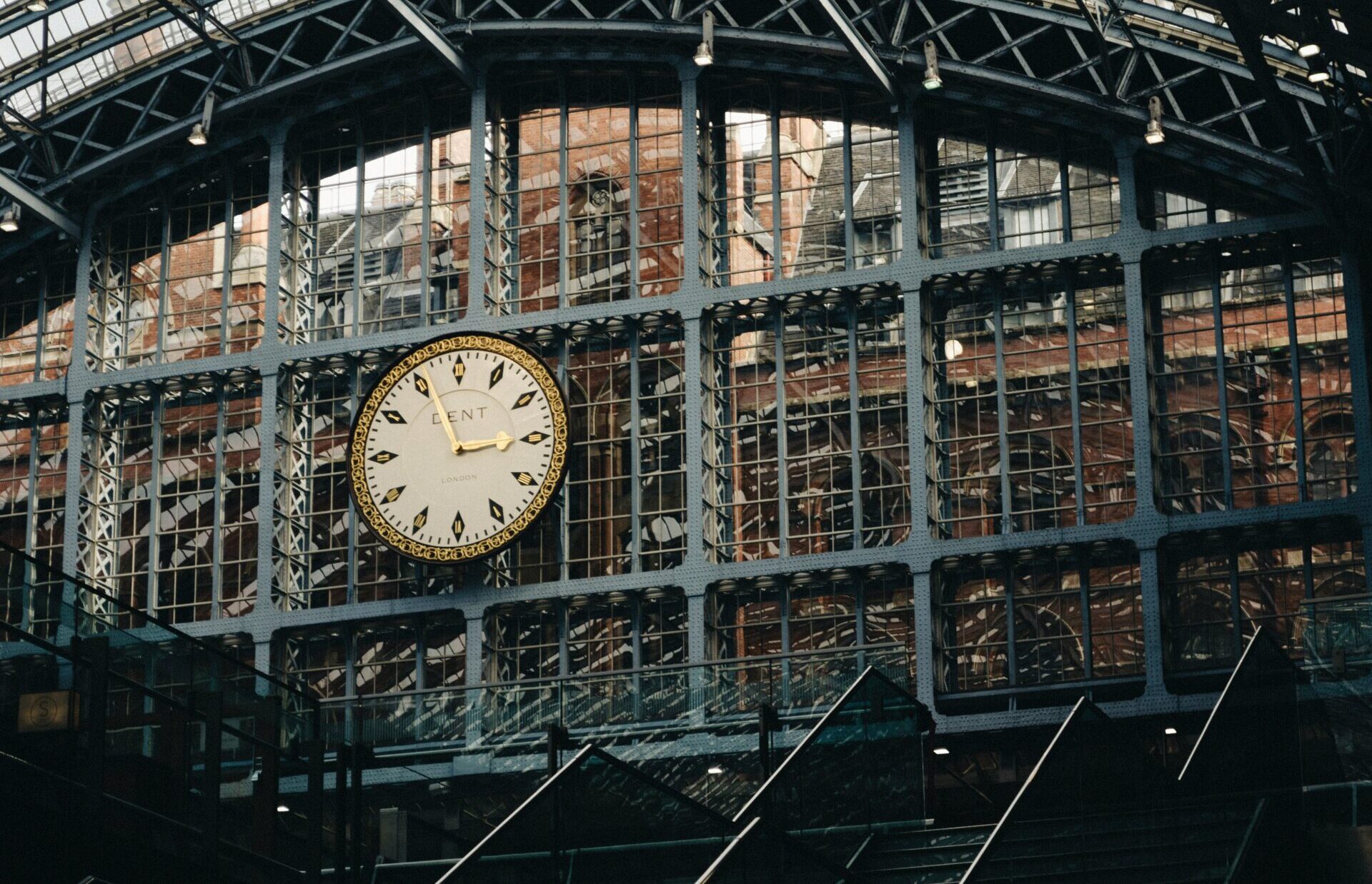 Ornate clock on industrial metal structure